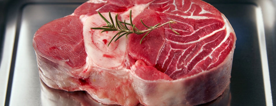 Piece of Leg Angus Steak With Rosemary Leaf on Top. Inside Steel Pan 